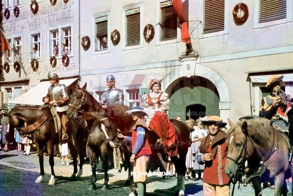 Medieval town festival in Saxony Germany 1939. Medieval soldiers in full costume on horse in front of Bakery Otto Richter