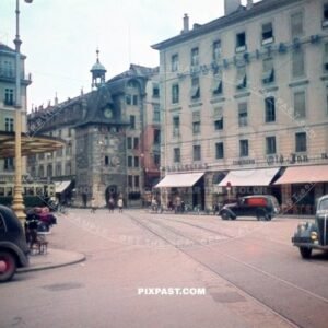 Molard Clock tower in Geneva city center Switzerland 1945. Classic cars. oldtimers. Vans and Hotels.