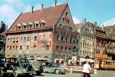 Old cars and tram in front of Weberhaus Maximiiliansttrasse Augsburg Germany summer 1938