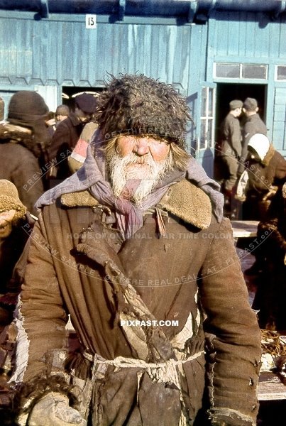 Portrait of a Russian peasant farmer in self made winter jacket and hat. Local market place. Russia 1942