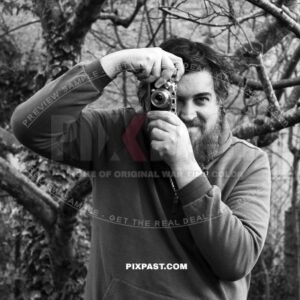 Portrait photo of Ian Stewart Spring with his Leica III built 1934 in 2025