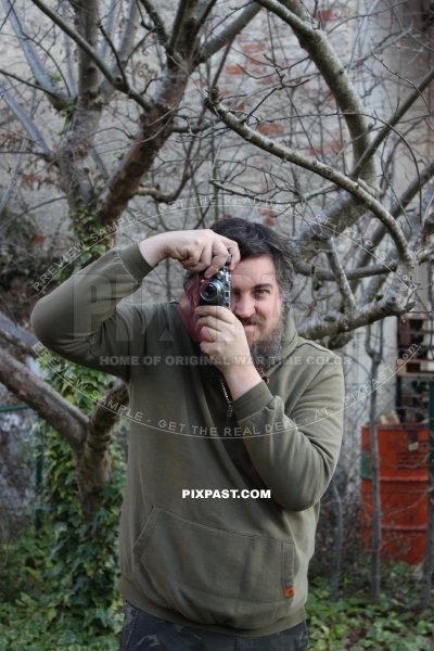 Portrait photo of Ian Stewart Spring with his Leica III built 1934 in 2025