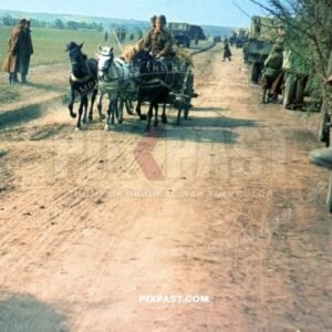 Romanian army retreating from Russian front line. Horse wagon and camouflage trucks flood dirt road. Russia 1944