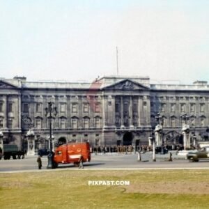 Royal Mail truck and American army staff car passing Buckingham Palace. London England 1944. Windows covered