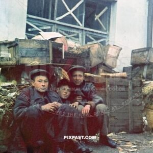 Russian homeless peasant boys sitting beside a waste heap near market in Smolensk. Russia 1942.