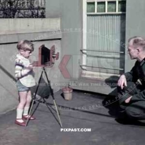 Soldier being photographed by his son in Leipzig, Germany 1940