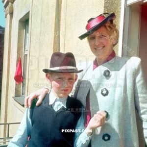 Son and his mother standing on balcony looking at the army preparation for Hitlers Birthday army parade Munich 1939