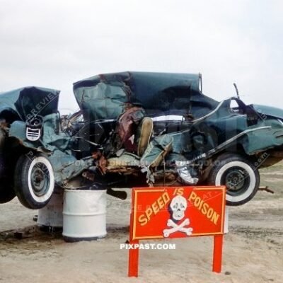 Speed is Poison. Crashed car put on petrol barrels outside of an American US army barracks in Germany 1949