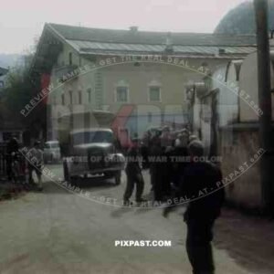 Surrendered German soldiers reading American Allied General Orders on wall in Kossen Austria 1945