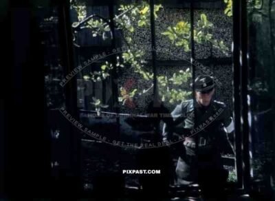 Surrendering SS Panzer officer standing guard outside of Hotel with American soldiers / pre surrender Schwendt Austria 1945