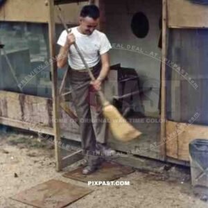 Sweeping in front of the barracks in Okinawa, Japan 1946