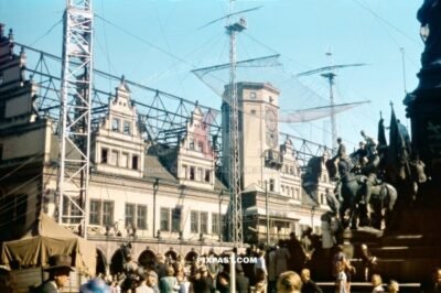 The Alte Rathaus in Markt Leipzig 1945. Children climbing on the Kaiser Siegesdenkmal and watching a circus performance