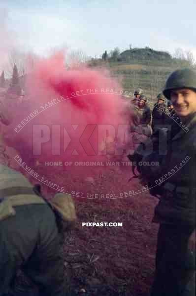 The Blue Devils US 88th Infantry Division training with smoke grenades in Italy 1944. GI holding his captured German helmet