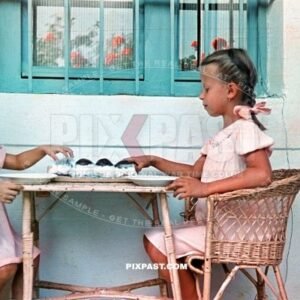 Two little girls eat cream cakes in Budapest Hungary summer 1940