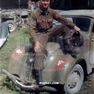 US Army officer of the 101ST CAVALRY REGIMENT. Sitting on a  captured Germany army car Peugot 202. Schwendt Austria 1945