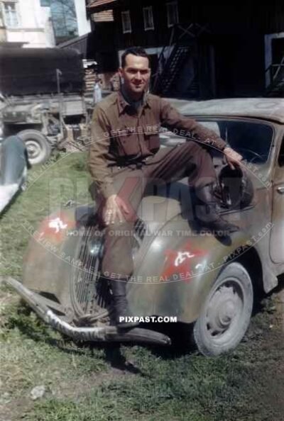 US Army officer of the 101ST CAVALRY REGIMENT. Sitting on a captured Germany army car Peugot 202. Schwendt Austria 1945