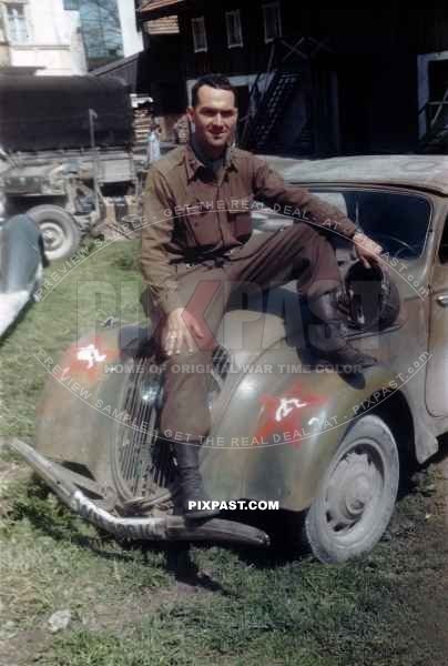US Army officer of the 101ST CAVALRY REGIMENT. Sitting on a captured Germany army car Peugot 202. Schwendt Austria 1945