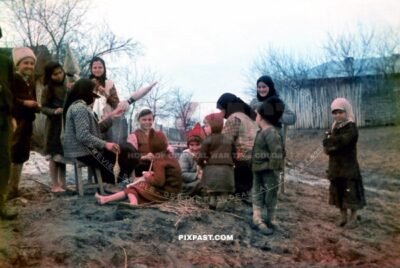 Ukrainian farming children playing in the mud. Spinning cloth. Eastern Ukraine 1942
