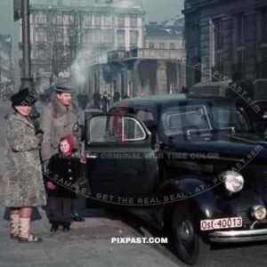 WW2 color Warsaw Ghetto German Business man with family car camera OST 1939 Poland winter city horse wagon