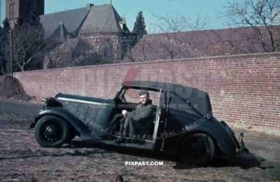 Wehrmacht soldier with car in Niederaußem, Germany 1940