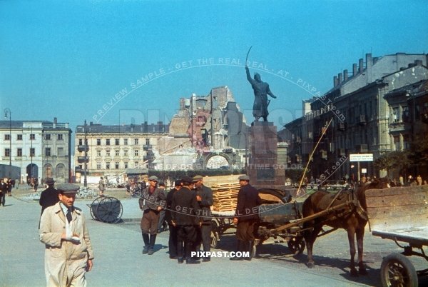 Wounded polish man and street cleaners removing rubble from the market. Jan Kilinski Monument, Warsaw Poland 1939