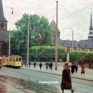 Yellow Number 2 Tram Strassenbahn passing St. Johann Baptist Church in Essen Germany 1941. Bomb monument red fin.