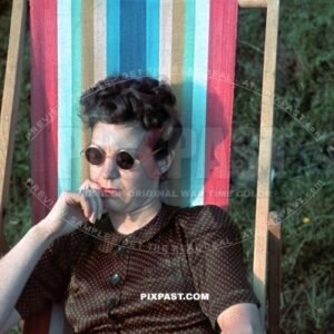 Young Austrian women wearing sun glasses relax in sun chair. Austria 1939