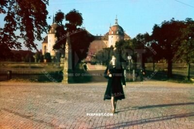 Young German lady standing with red hand bag in front of Schloss Moritzburg Saxony Germany 1942