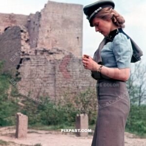 Young attractive wife of a infantry Wehrmacht officer wearing his army Peaked cap Schirmmutze. Lindau Germany 1944