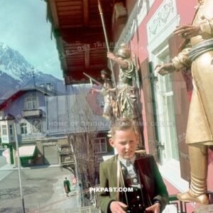 Young boy in Bayerische Tracht, binoculars on the balcony of Atlas Post Hotel. Garmisch Partenkirchen Bavaria Germany 1939