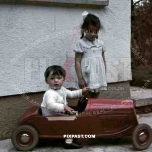 boy and girl playing with a toy car, Germany 1940