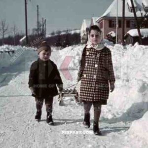 boy and girl pulling sledge, Germany 1942