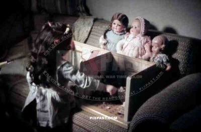 little girl playing with her dolls and dollhouse, Germany 1938