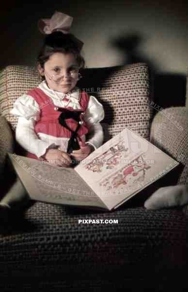 little girl with reading glasses and a children´s book, Germany 1938