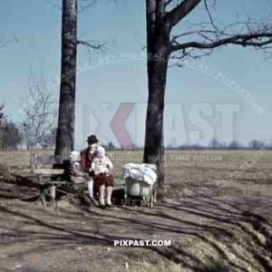 mother sitting on a bench with her two children, Germany 1938