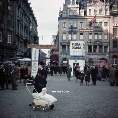 mother with baby in a pram at the market place in Leipzig, Germany 1941