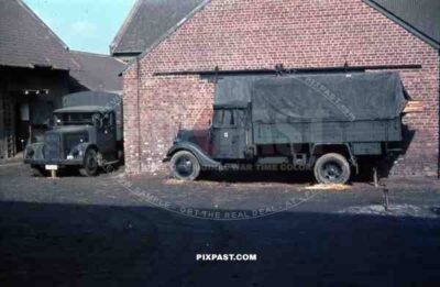 parked trucks at Wehrmacht quarter in Niederaußem, Germany 1940