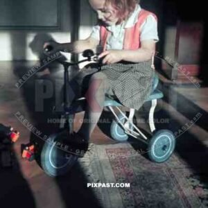 young girl riding a tricycle, germany