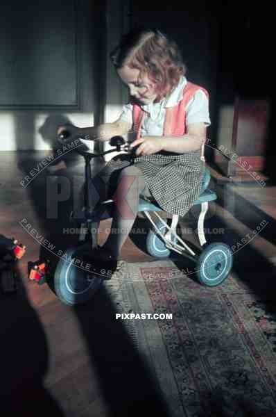 young girl riding a tricycle, germany
