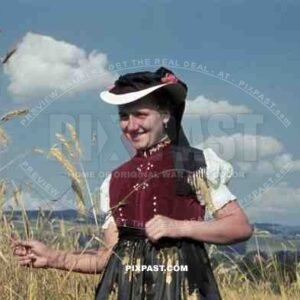 young woman in traditional costume in a field, Germany ~1938